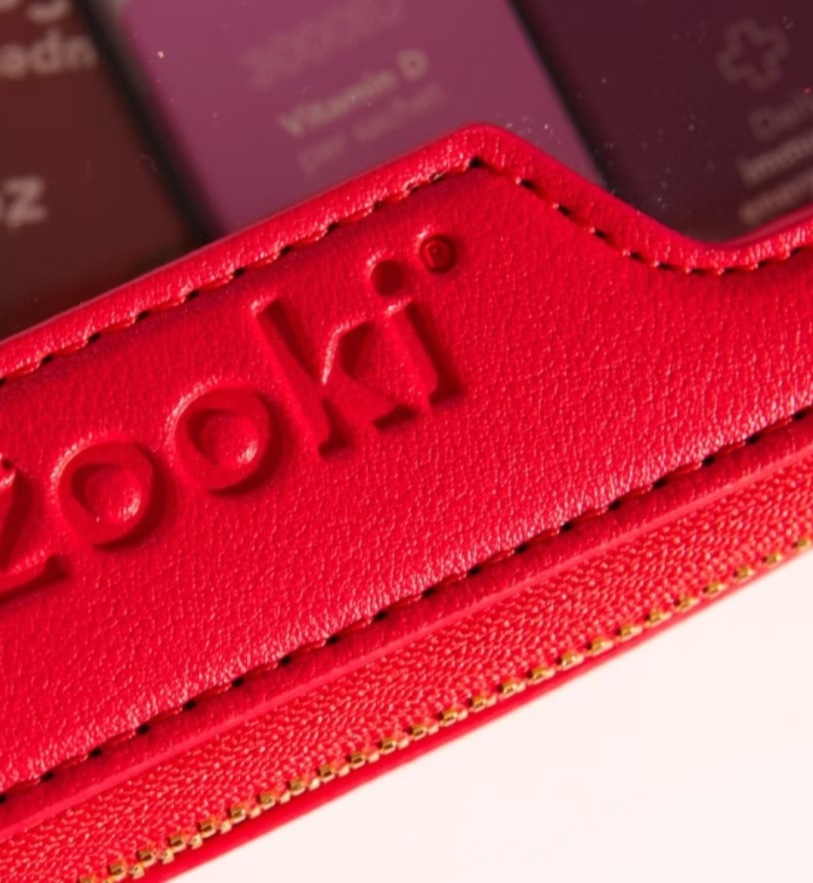 Zooki Glow Heroes gift set with sachet products inside a red travel make-up bag